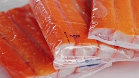 Crab sticks on a plate in packaging, rotating salad ingredient. Stock-Footage 326199568