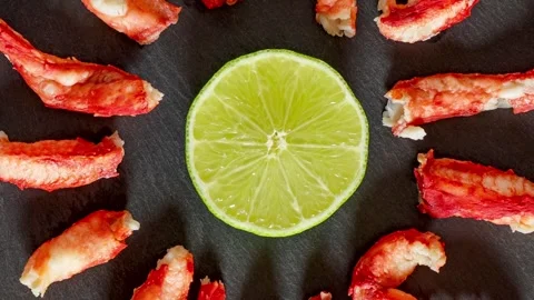 Crabs and lime on slate surface dark rotating, turning Stock Footage 240639893