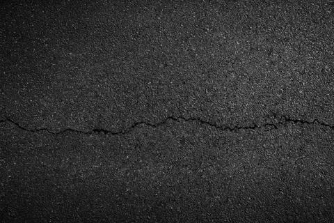 Crack background texture of rough asphalt Stock Photos