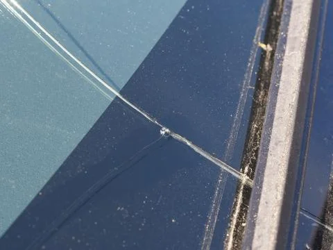 Crack on the car windscreen from a stone close-up. Stock Photos