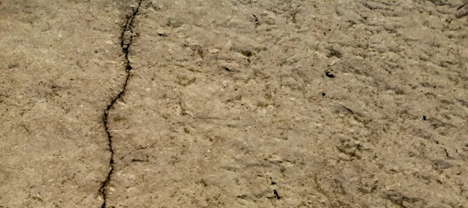 Crack in the cement base. Split in cement floor. There is a rupture on the gr Stock Photos