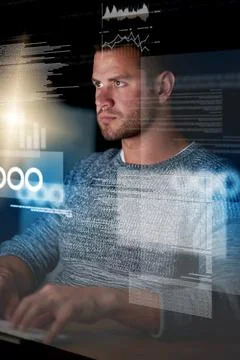 Crack the code, solve the problem. a focussed computer programmer working at his Stock Photos