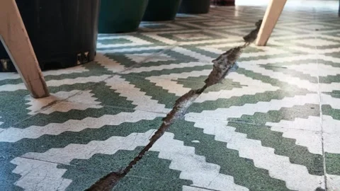 Crack develops in tile flooring during building inspection Stock Footage 346514818