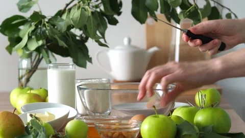 Crack an egg into an apple pie bowl. The process of adding dough ingredients. Au Stock Footage 248378268
