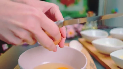 Crack an egg into a deep bowl Stock-Footage 249625603