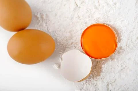 Crack egg on flour Stock Photos