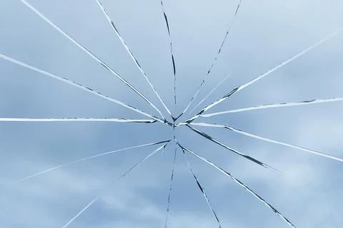 Crack on the glass against the sky, broken glass Stock Photos