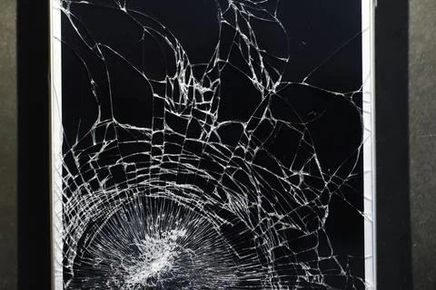 Crack on the glass. Broken screen. Broken phone. Cracked glass background. Wh Stock Photos