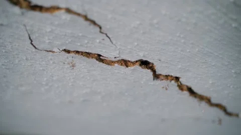 A crack has formed in the ceiling close-up. The clay ceiling of an old rural Stock Footage 210498381