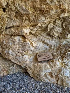 A crack into Hell in the rock in Greece Stock Photos