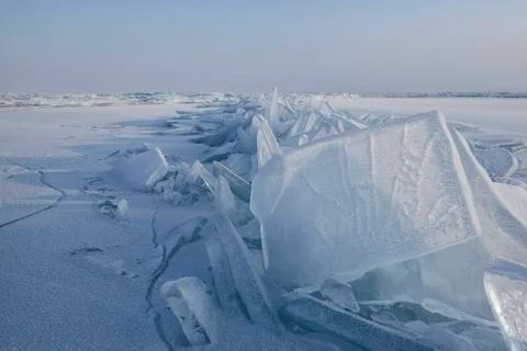 Crack in the ice and standing vertically ice on lake Baikal Stock Photos