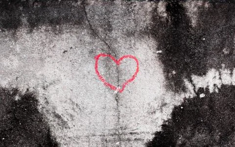 Crack in red heart sharp by hand write of old white concrete wall Stock Photos