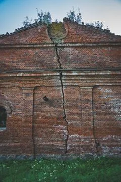 A crack in the wall of a brick building. The stable. 19th century buildings Stock Photos
