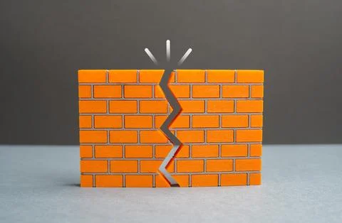 A crack in the wall. Issues with reliability. Lack of confidence in strengt.. Stock Photos
