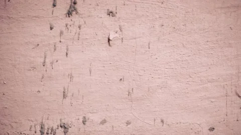 A crack in the white clay wall of an old house. Close-up camera movement along Video stock 235733185