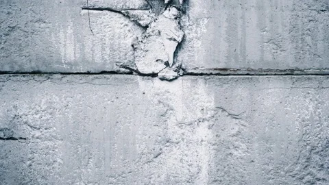 A crack in the white clay wall of an old house. Close-up camera movement along Video stock 235733248