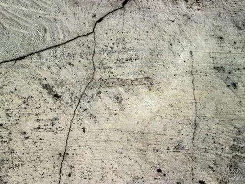 A crack in a white concrete wall. Destroyed old building. The effect of an .. Stock Photos