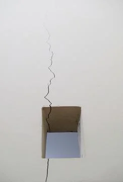 Crack on the white wall. Stock Photos