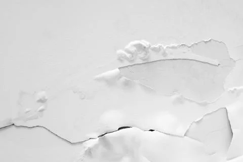 Crack on a white wall. Plaster crumbles from the ceiling. Stock Photos