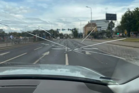 Crack on the windshield of the car, a trace of a stone on the road Stock Photos