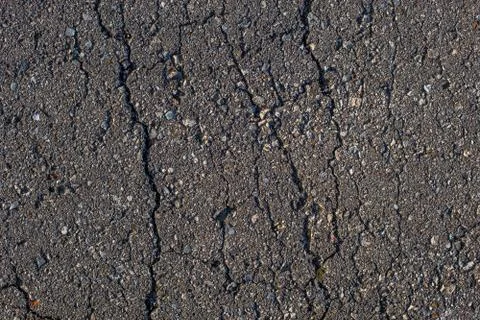 Cracked across asphalt texture Stockfoto's