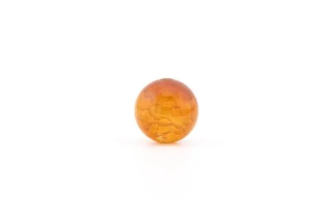 Cracked agate sphere on a plain surface in bright light Stock Photos