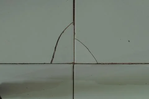 Cracked And Chipped Light Blue Ceramic Tile Floor With Dirty Grout Stock Photos
