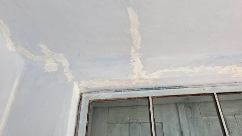 Cracked and Peeling Ceiling Around an Old Window in a Neglected Room Stock Footage 344756809