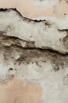Cracked and Textured Wall with Layers of Plaster and Stone for Rustic Appeal Stock Photos