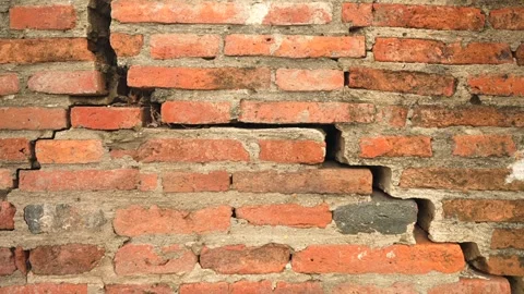 Cracked antique red brick wall with aged lines and crumbling surface from temple Vidéo 312662040