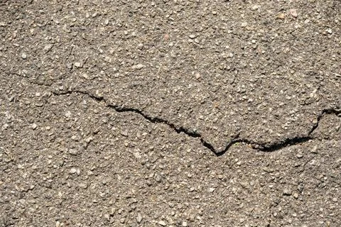 Cracked Asphalt Pavement Texture with Rough Stone Aggregate Stock Photos