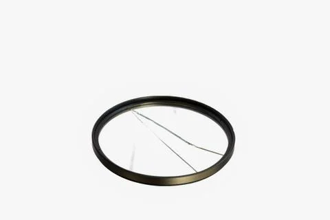 Cracked camera filter isolated on white background Stock Photos