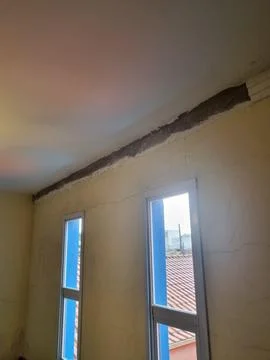 Cracked ceiling and wall inside Stock Photos