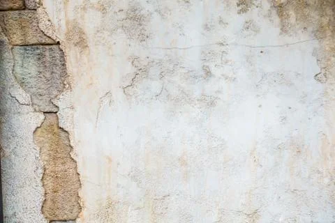 Cracked cement wall with stone bricks inside Stock Photos