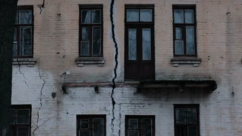 Cracked collapsed house. Crack in the wall foundation of an old house closeup Stock Footage 158089175