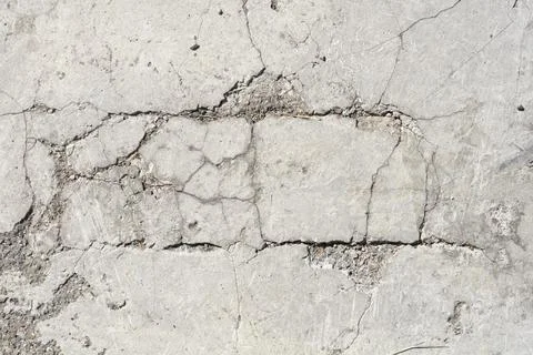 Cracked concrete pavement texture in a horizontal full frame background Stock Photos