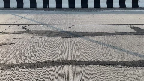 Cracked Concrete Road Surface Tracking Shot Stock Footage 337110526