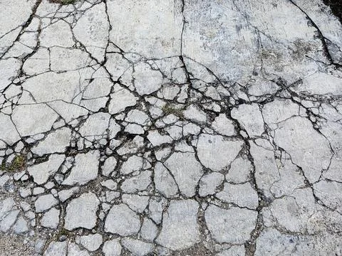 Cracked Concrete Surface Texture Background with Broken Pavement Pattern Stock Photos
