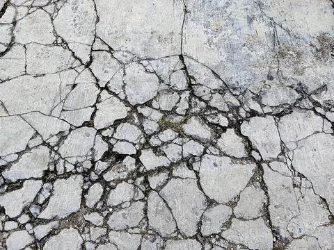 Cracked Concrete Surface Texture Background with Broken Pavement Pattern Stock Photos