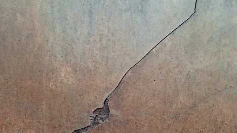 Cracked concrete wall texture covered with gray cement	 Stock Footage 326296161