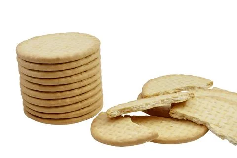 Cracked crackers next to stack of round whole bread crackers isolated on white b Stock-Fotos