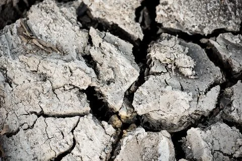 Cracked drought ground surface background. Disaster concept. Photos