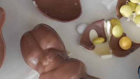 Cracked Easter Chocolate Eggs with Colorful Candies Inside Stock Footage 332944239