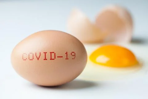 Cracked Easter egg, yolk and egg white spilled around Stock Photos