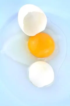 Cracked egg in cup Stock Photos