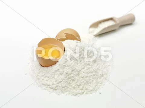 A cracked egg in flour Stock Photos