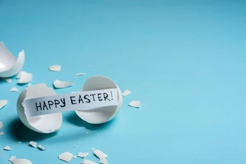 Cracked egg on light blue background Stock Photos