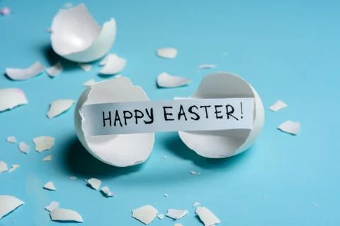 Cracked egg on light blue background Stock Photos