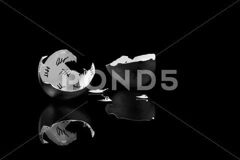 Cracked egg shell with countdown on black background, monochrome Stock Photos