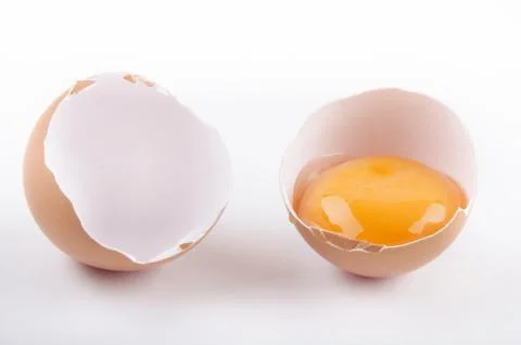 Cracked empty eggshell and yolk Stock Photos
